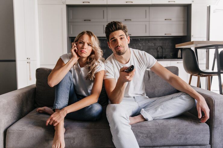 Young couple watching premium movies and TV shows on multiple devices